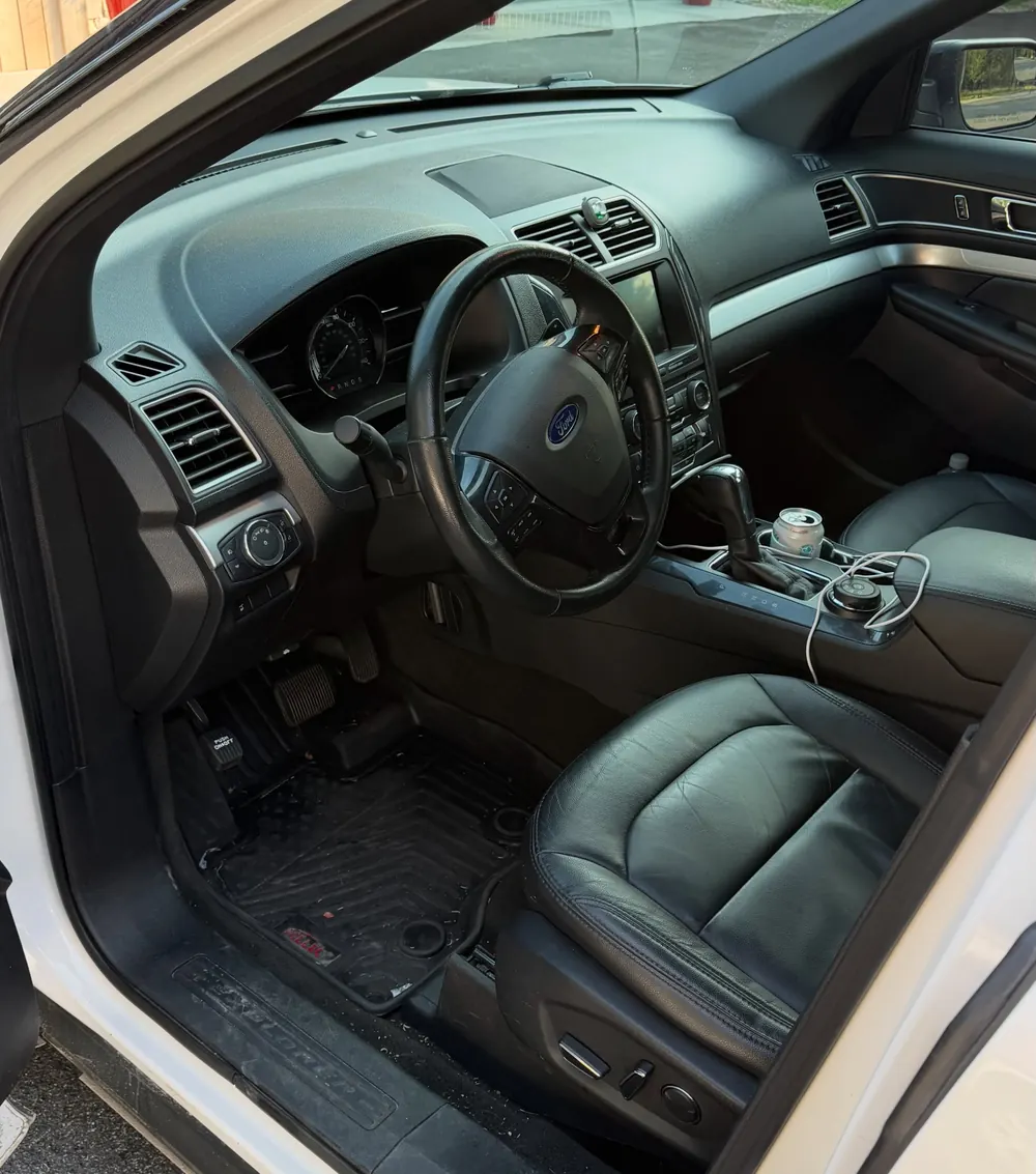Ford Explorer interior with black leather seats after a bimonthly maintenance detail
