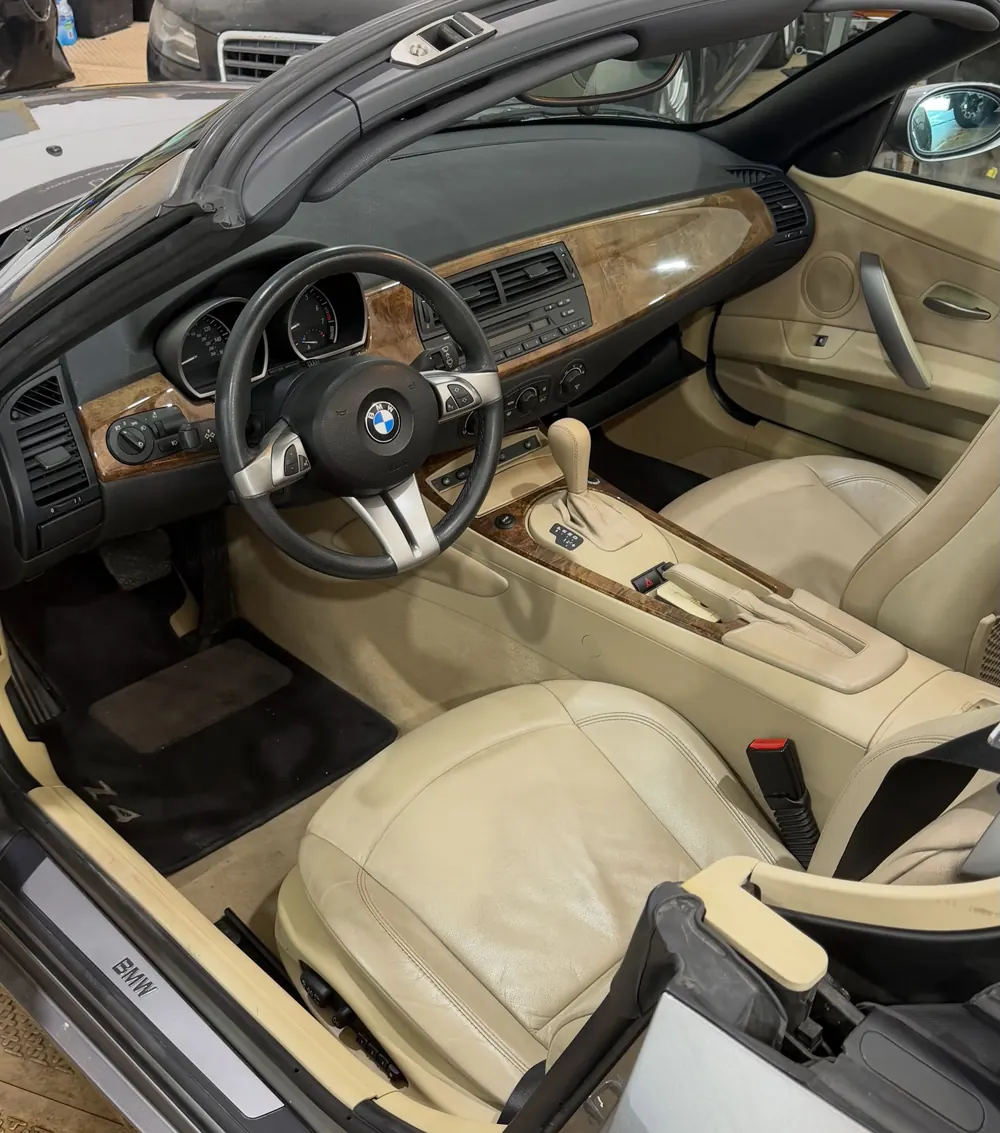 BMW Z4 interior with cream leather seats after an interior detail and odor removal